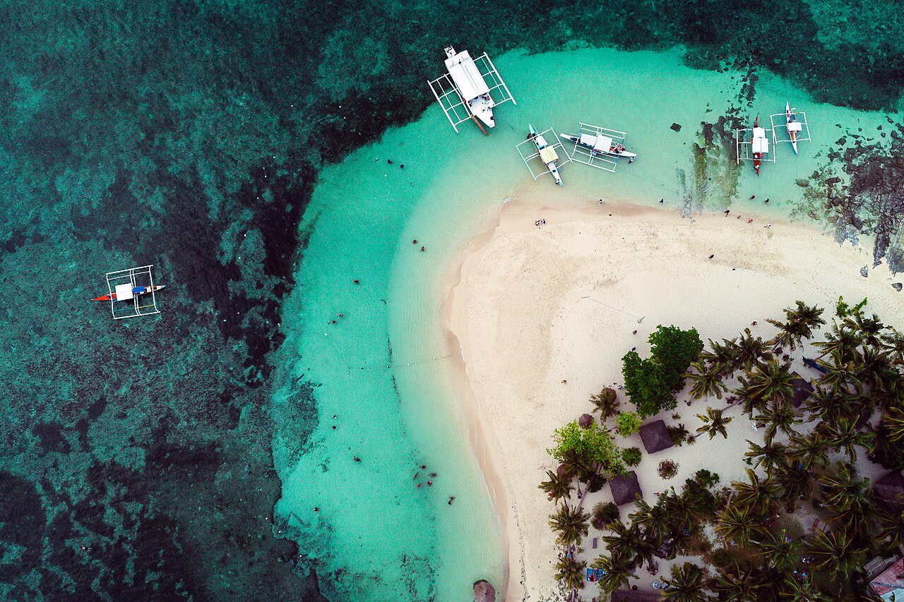 A compact palm-ringed island often combined with the classic island-hopping circuit from General Luna.